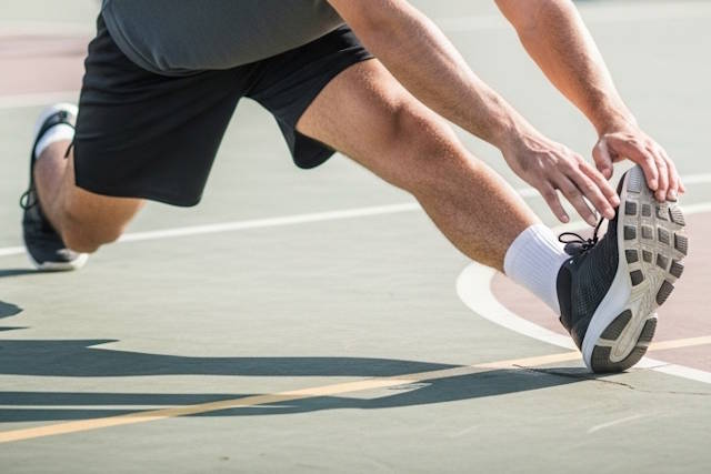 ספורטאי מתStretching על מגרש כדורסל
